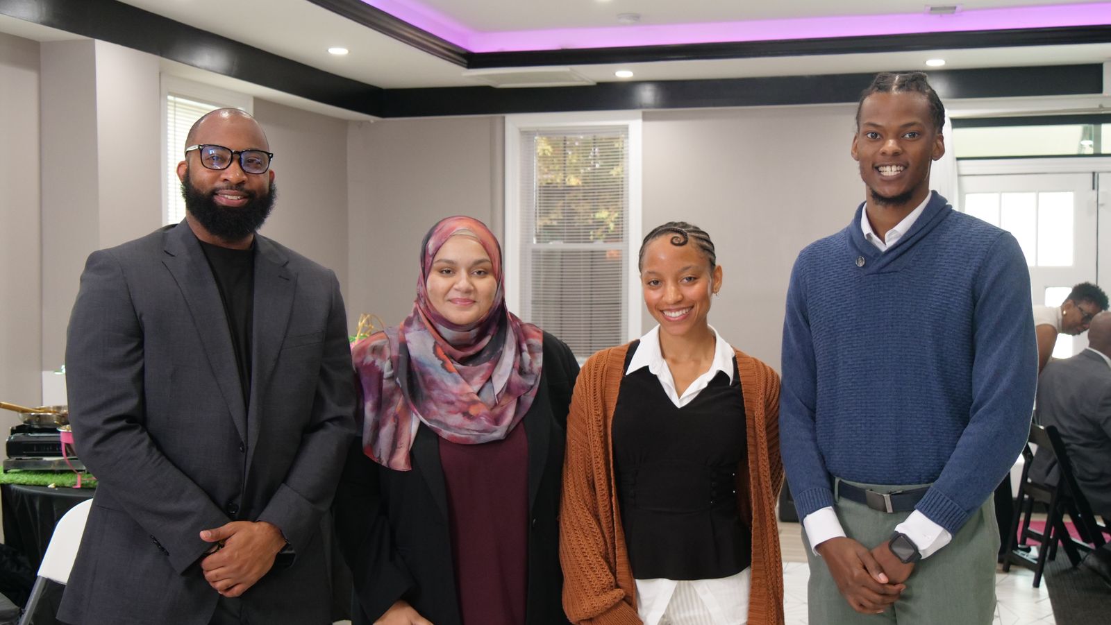 Four members of the Business & Economic Advancement pillar standing together at the ABLE Leadership Lab