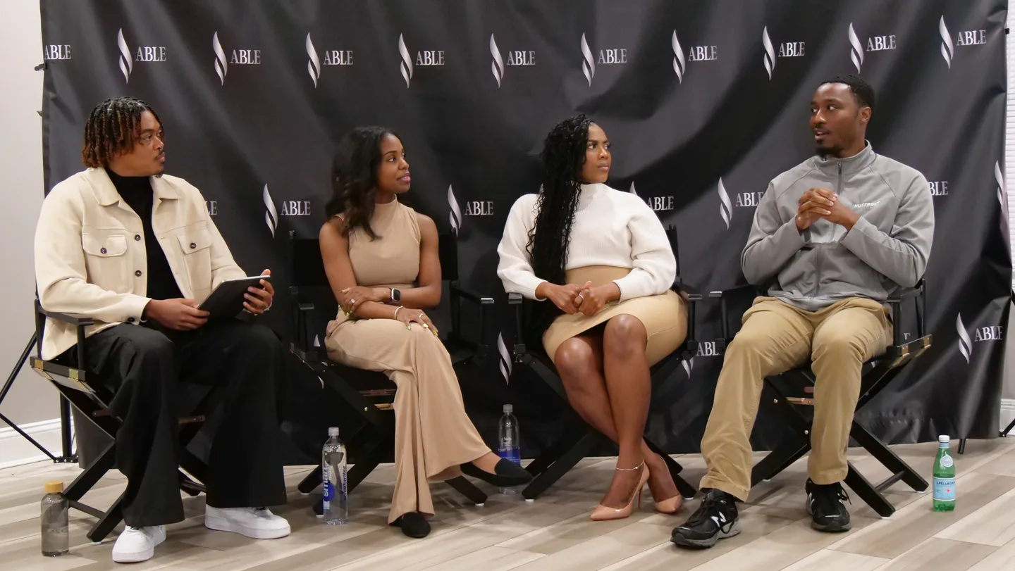 Four panelists in conversation in front of the ABLE backdrop at the Leadership Lab